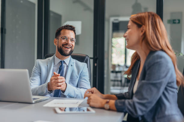 istock Four business professionals discussing in a modern office setting. 2169204615