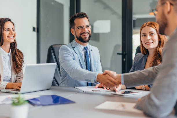 istock Businessmen shaking hands across the table 2169205163