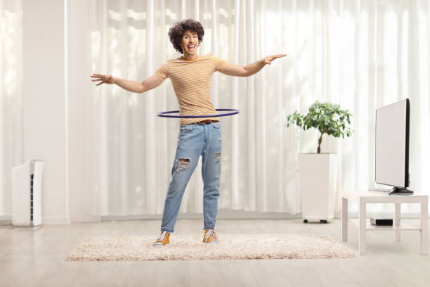 istock Happy young man spinning a hula hoop 2169205189