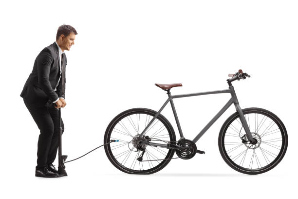 istock Businessman pumping a flat bicycle tire 2169205190