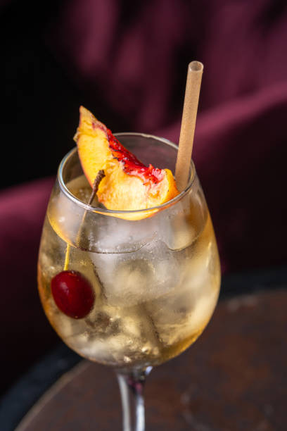 istock Peach cocktail in glass on dark background 2169205415