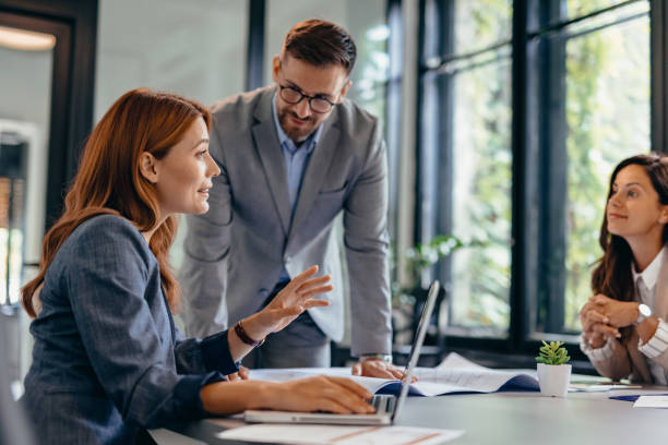 istock Business professionals discussing about work at a modern office table. 2169205857