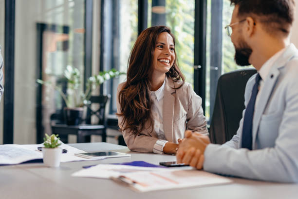 istock Business professionals discussing about work at a modern office table. 2169206729