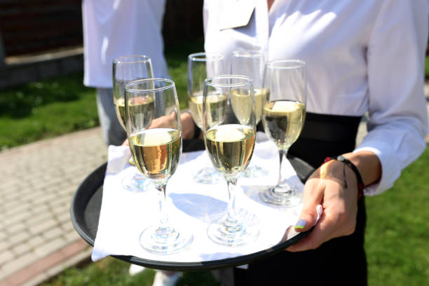 istock They are holding a tray with champagne glasses. 2169207152