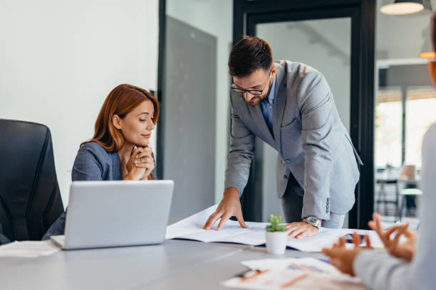 istock Business professionals discussing about work at a modern office table. 2169207202
