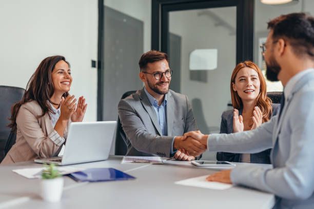 istock Businessmen shaking hands across the table 2169210177