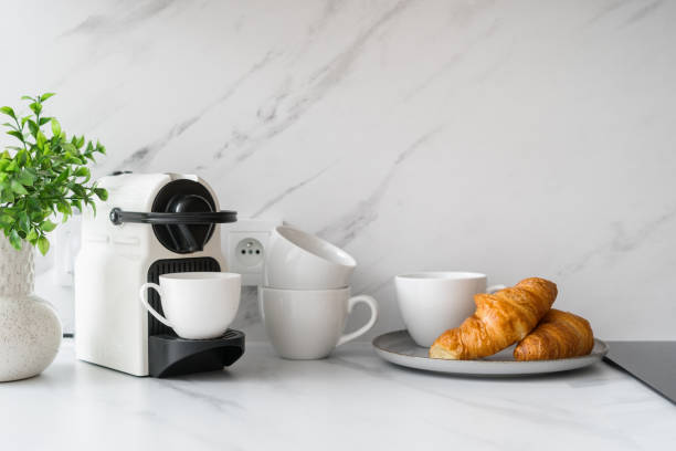 istock White espresso machine and croissants on marble countertop 2169210946
