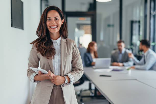 istock Business woman holding a tablet in a modern office setting. 2169213074