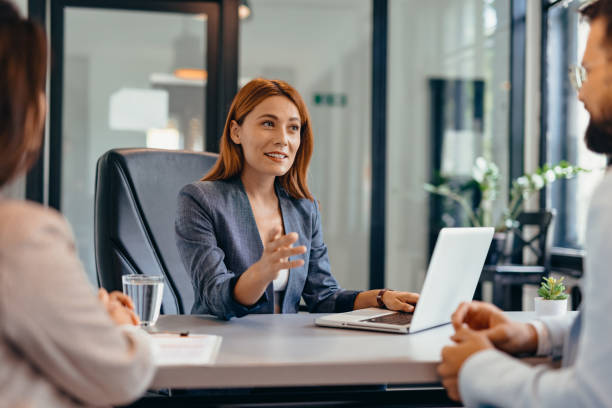 istock Three professionals in a discussion at an office meeting setting. 2169213077