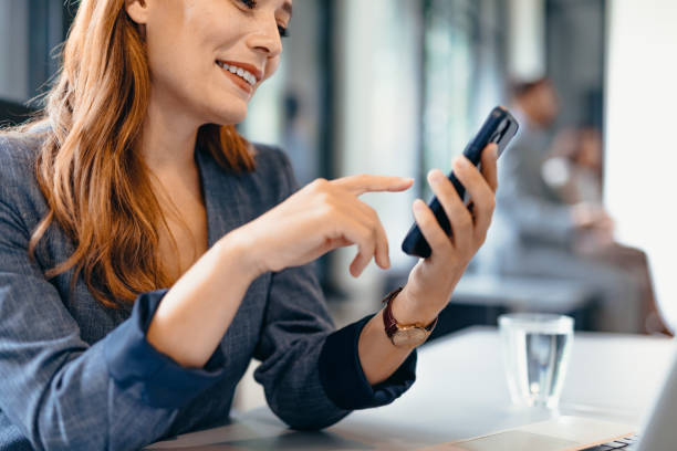 istock Professional woman with smartphone working in modern office setting 2169213091