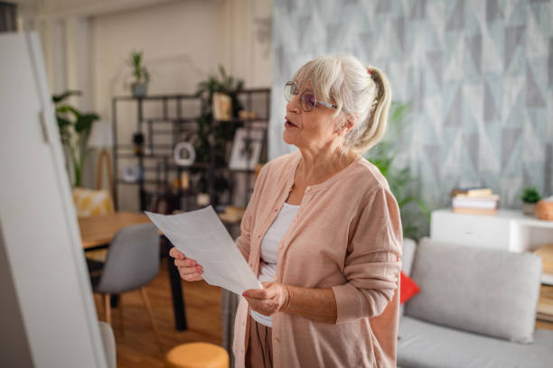 istock Senior Woman Preparing Speech with Mirror at Home 2169213217