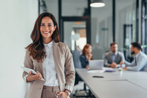 istock Business woman holding a tablet in a modern office setting. 2169213522