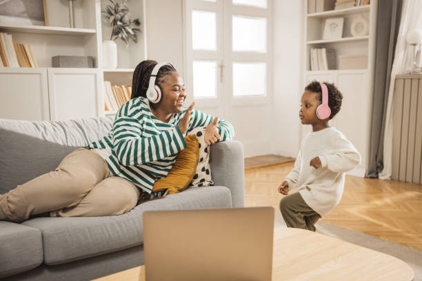 Dancing all day at home Mother and baby boy listening music and dancing. Wearing headphones. baby boy dancing with his mommy stock pictures, royalty-free photos & images