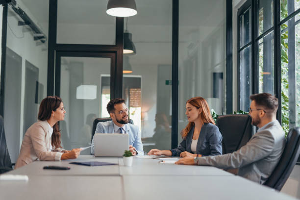 istock Team meeting in modern office with four engaged professionals 2169213934