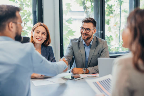 istock Business meeting with handshake between partners in modern office. 2169214273