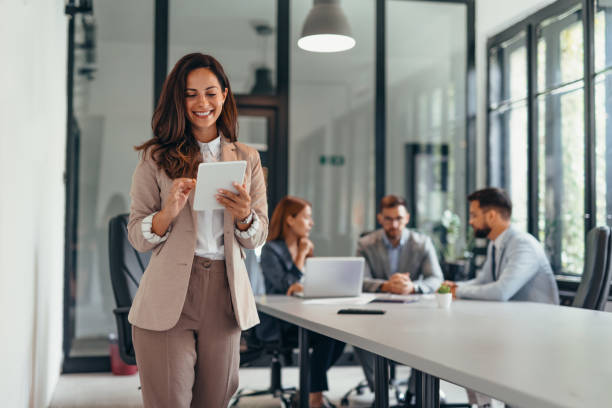 istock Business woman holding a tablet in a modern office setting. 2169214277