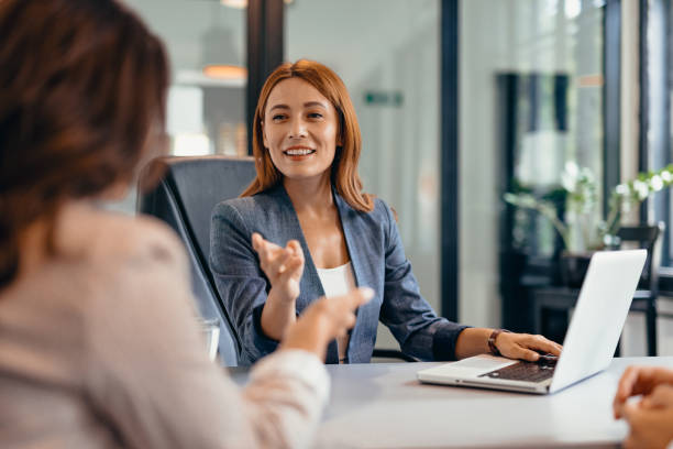 istock Three professionals in a discussion at an office meeting setting. 2169214285