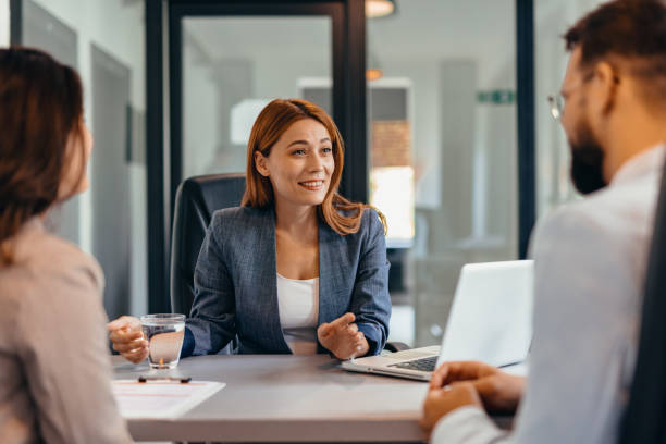 istock Three professionals in a discussion at an office meeting setting. 2169214833