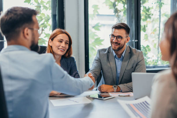 istock Business meeting with handshake between partners in modern office. 2169215437