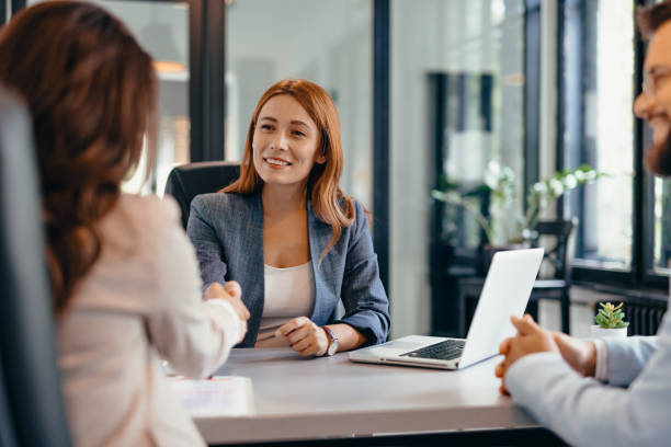 istock Three professionals in a discussion at an office meeting setting. 2169215455
