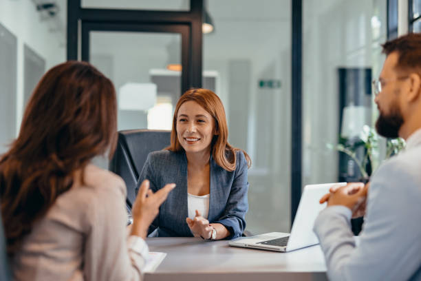 istock Three professionals in a discussion at an office meeting setting. 2169215456