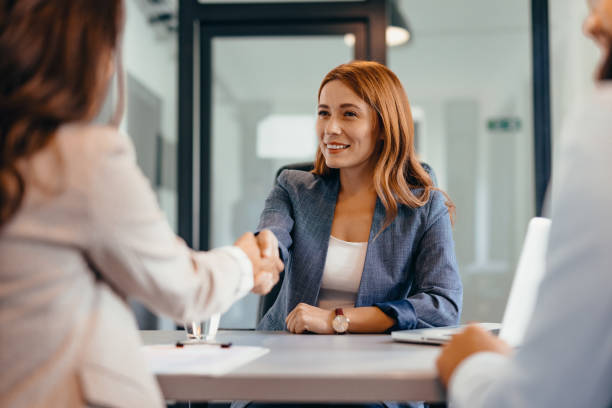 istock Three professionals in a discussion at an office meeting setting. 2169215762