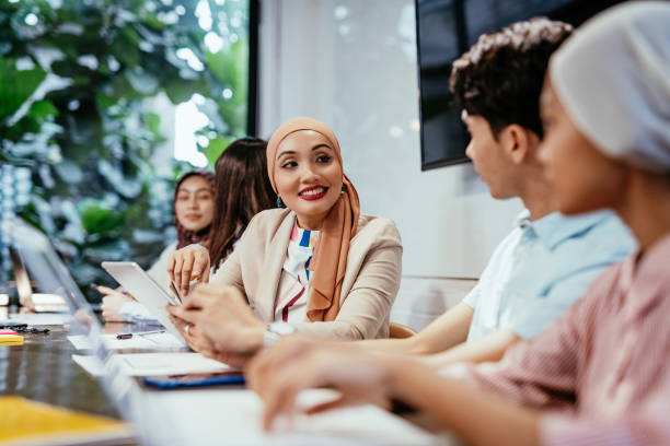 istock A diverse group of young professionals collaborating in a modern office environment, discussing ideas and working on a project 2169216701