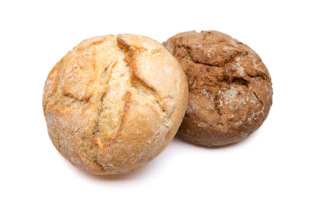 Two freshly baked bread rolls, one light and one dark, isolated on a white background