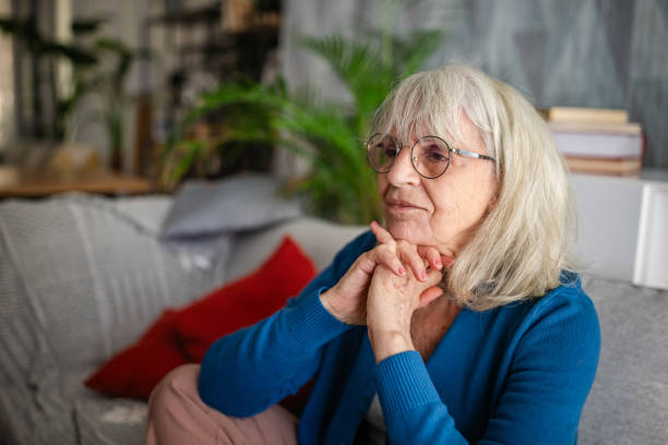 istock Thoughtful senior woman resting on sofa at home 2169217850