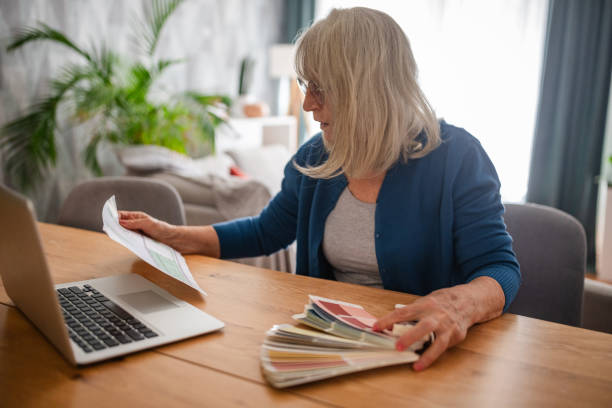 istock Woman choosing paint colors using laptop at home 2169218145