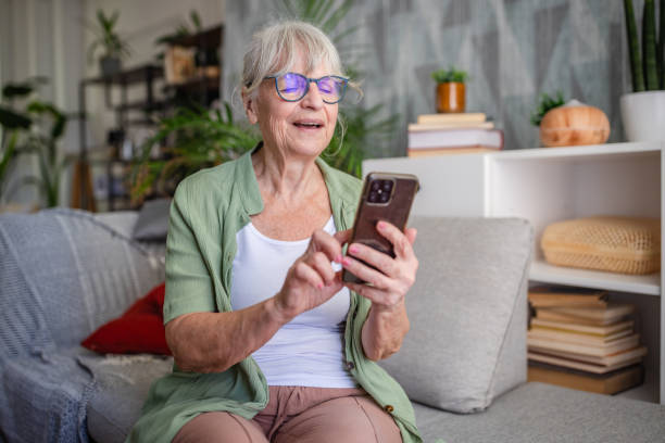 istock Woman enjoying her smartphone while sitting on sofa. 2169218395