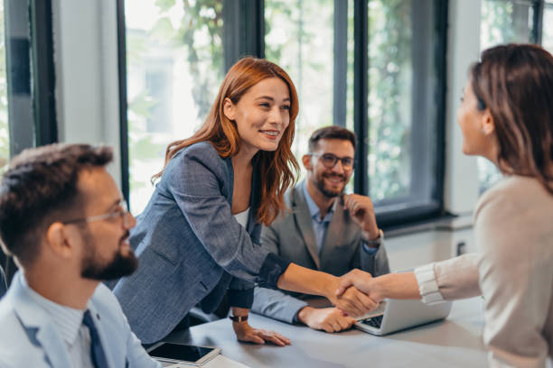 istock Business meeting handshake in modern office setting. 2169218998