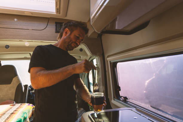 istock Man Brewing Tea with a Tea Bag in Camper Van 2169219061