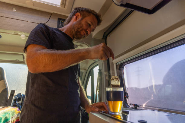 istock Man Brewing Tea with a Tea Bag in Camper Van 2169219064