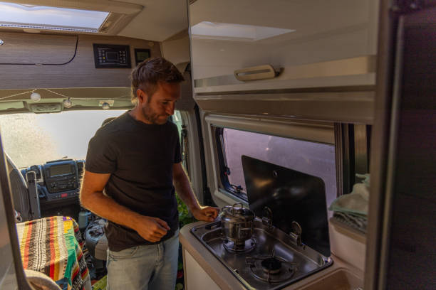 istock Man Cooking on a Stove in a Camper Van 2169219111