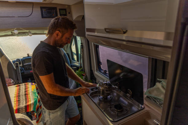 istock Man Cooking on a Stove in a Camper Van 2169219119