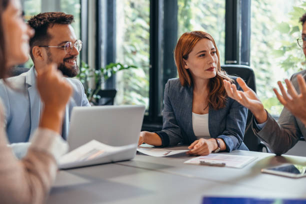 istock Group meeting in modern office space with laptops, papers 2169219162