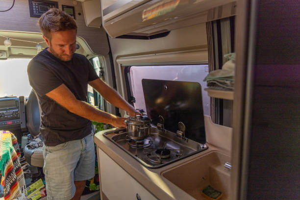 istock Man Cooking on a Stove in a Camper Van 2169219173