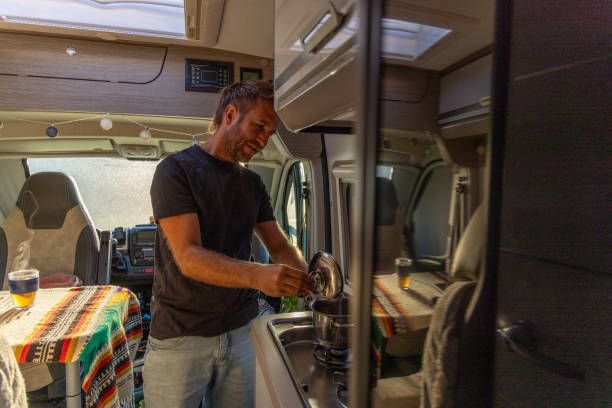 istock Man Cooking on a Stove in a Camper Van 2169219225