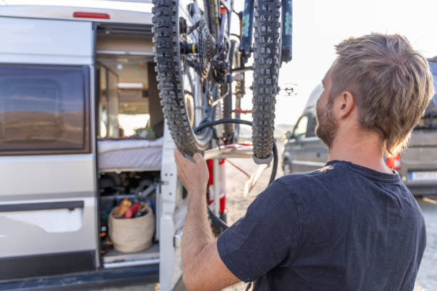 istock Man Loading Mountain Bike on Camper Van Rack 2169219698