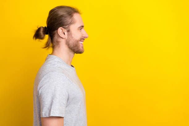 istock Side profile photo of optimistic nice man dressed gray t-shirt look empty space barbershop advertise isolated on yellow color background 2169220681