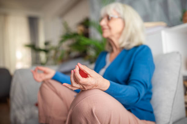 istock Person meditating while seated on a cushion indoors. 2169221445