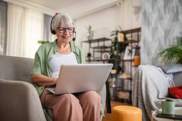 istock Senior female enjoying an online activity on laptop 2169221687