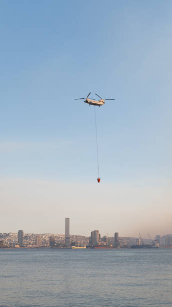 Firefighting helicopter takes water from the sea