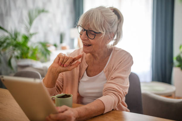 istock Senior woman pointing at a tablet while seated. 2169224757
