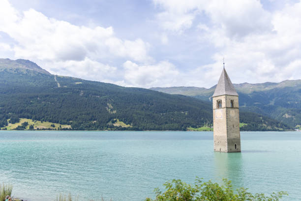 istock Submerged Bell Tower in Lake Resia with Mountainous Backdrop 2169225115