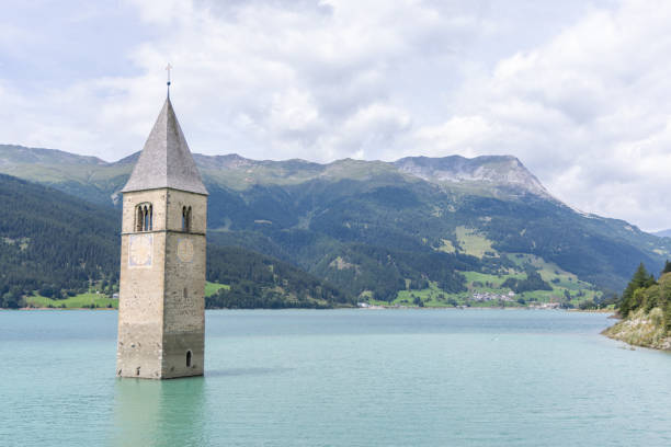 istock Submerged Bell Tower in Lake Resia with Mountainous Backdrop 2169225117