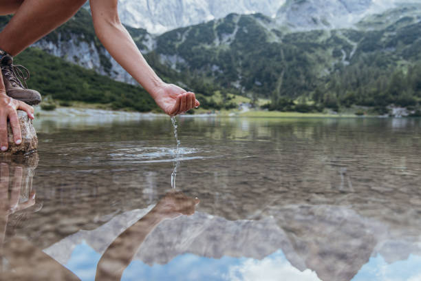 istock Hands Gently Cupping Fresh Water from a Pristine Alpine Lake 2169228235