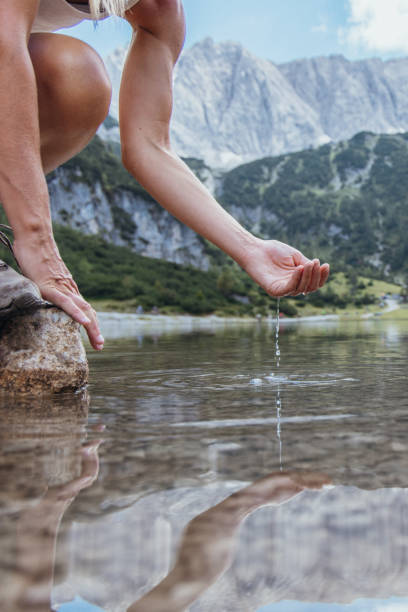 istock Hands Gently Cupping Fresh Water from a Pristine Alpine Lake 2169228278