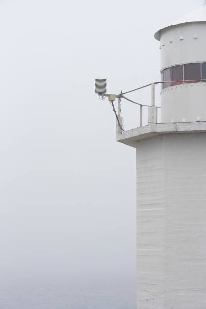 The side of the lighthouse in the fog after dawn